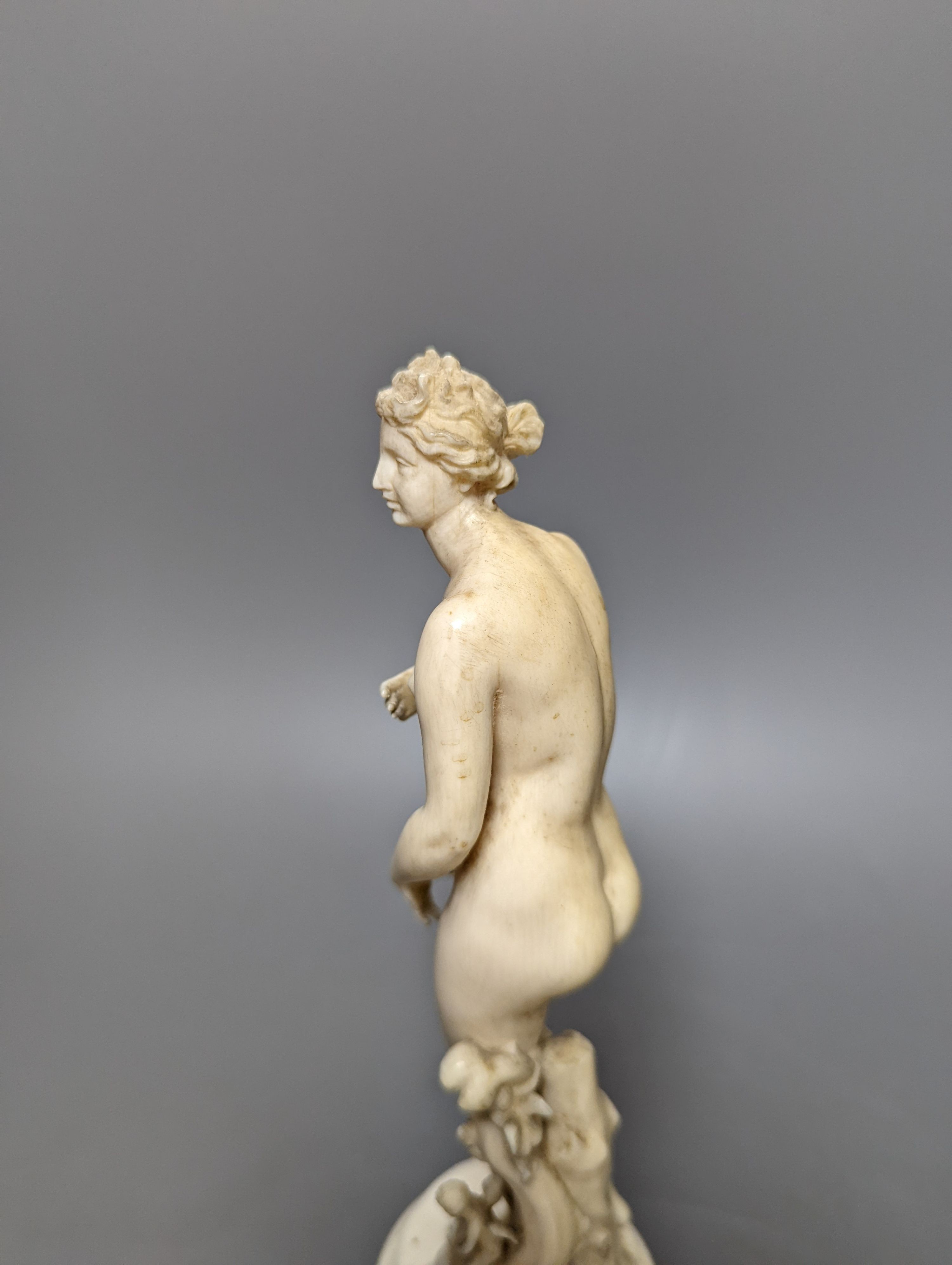 A 19th century Dieppe ivory figure after the antique ‘Venus with dolphin’ 25cm